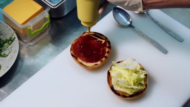 Een Hamburger Bakken Mosterd Toevoegen Een Broodje Met Ketchup Gedetailleerd — Stockvideo