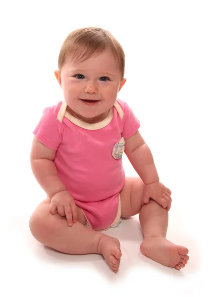 Menina bebê em colete rosa sentado — Fotografia de Stock