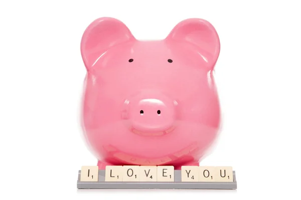 Piggy bank met ik hou van je scrabble tegels — Stockfoto