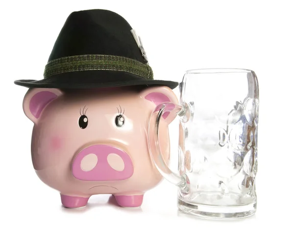 Sad piggy bank wearing beer festival hat and empty pint — Stock Photo, Image