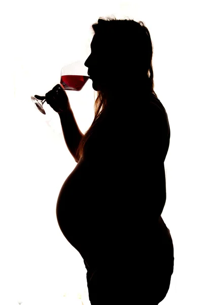Mulheres grávidas bebendo silhueta de vinho tinto — Fotografia de Stock