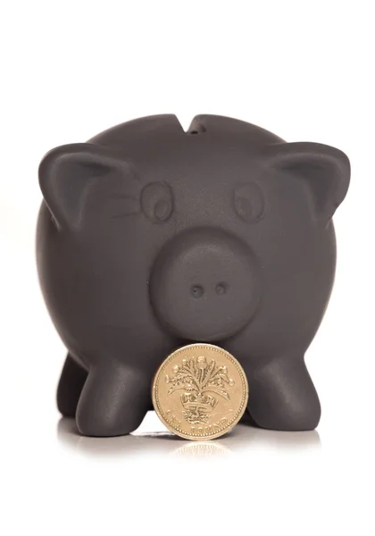 Sparschwein und Pfund-Münze am schwarzen Freitag — Stockfoto