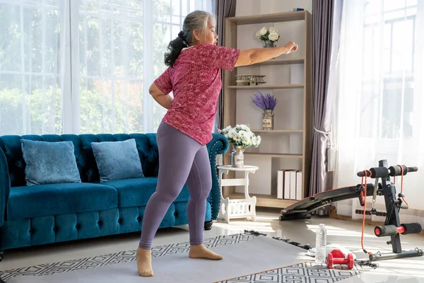Senior Woman Exercise Standing Boxing Jabs Side She Watch Laptop Stockfoto