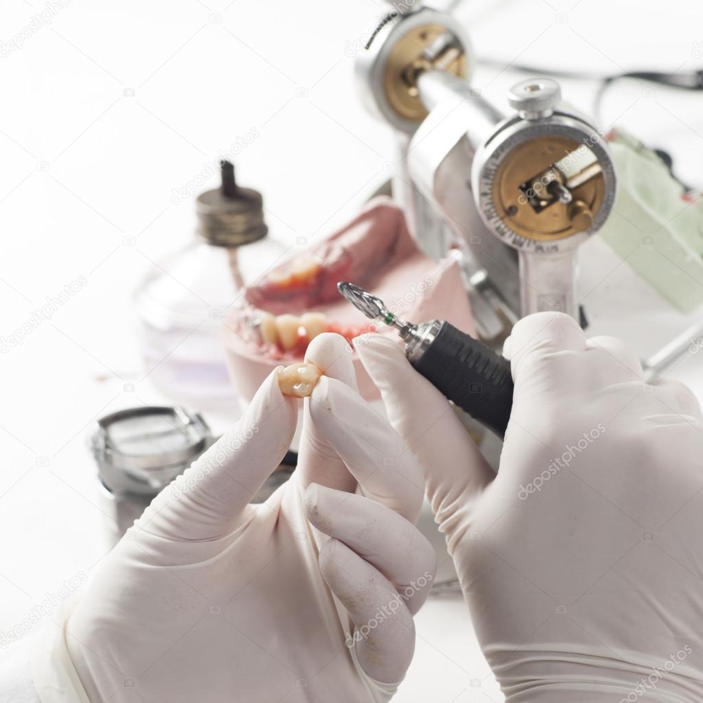 Dental technician working with articulator