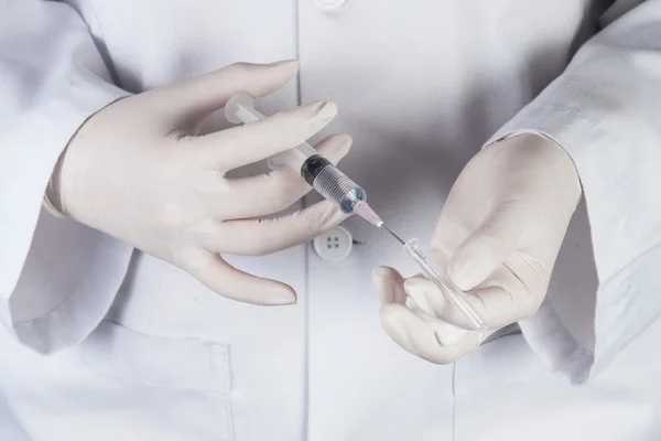 Doctor or Nurse holding a syringe — Stock Photo, Image