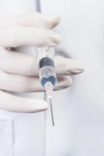 Doctor or Nurse holding a syringe ready an injection — Stock Photo, Image