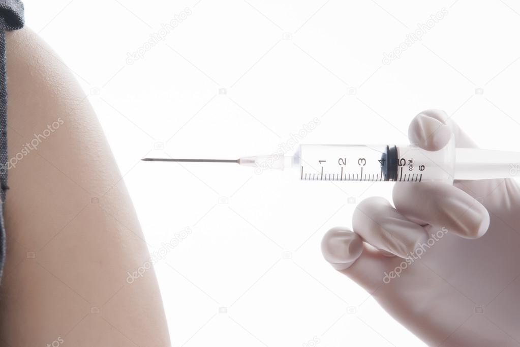 Doctor or Nurse holding a syringe give and injection