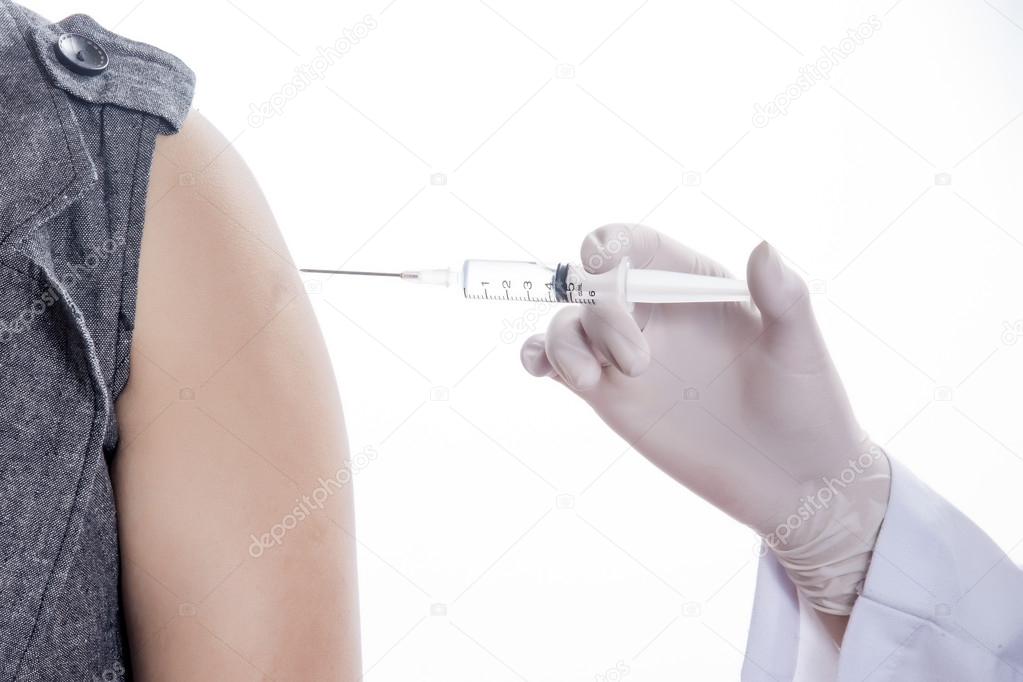 Doctor or Nurse holding a syringe give and injection