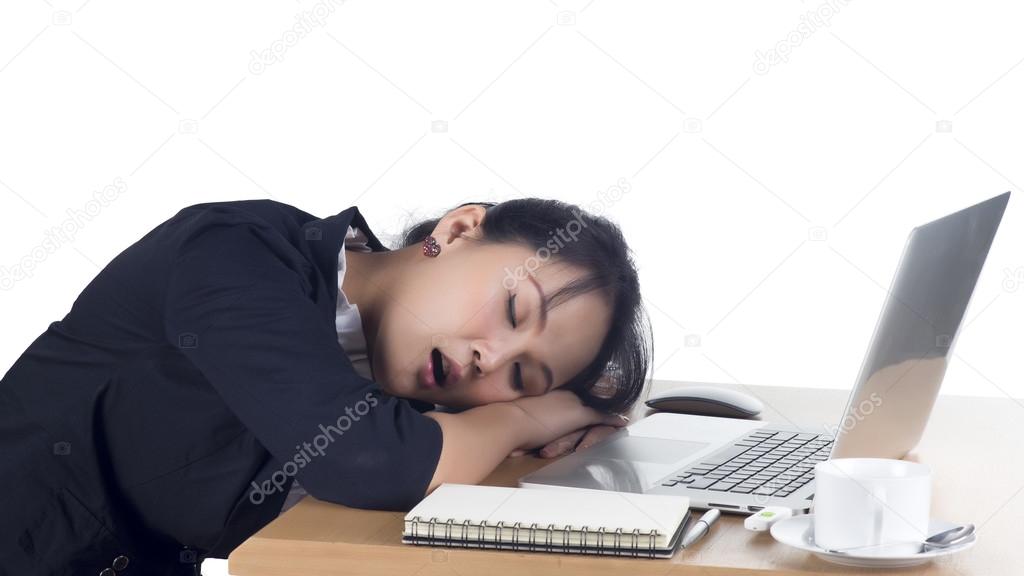 Tired business woman sleeping at her desk