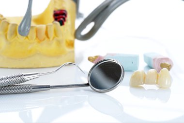 Macro of prosthetic teeth with dental tools clipart