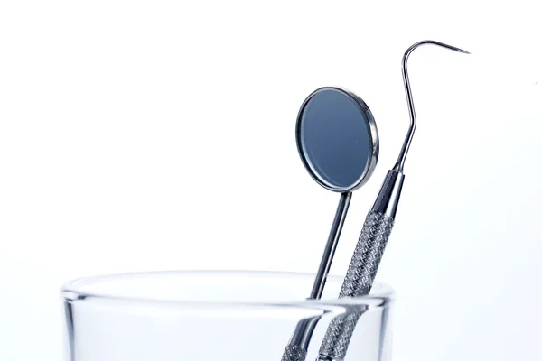 Two Dental Tools in the glass : Dental mirror and probe — Stock Photo, Image