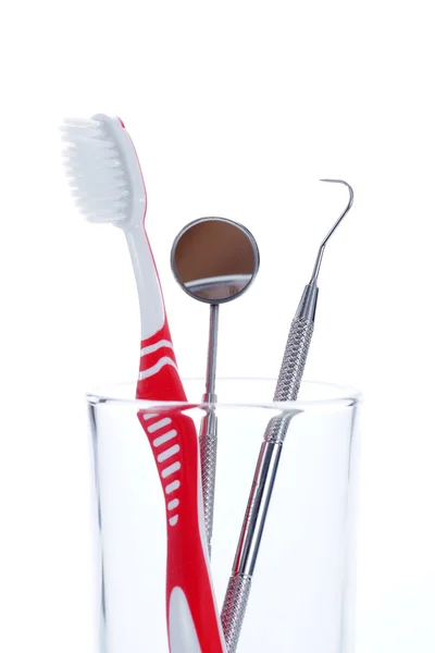 Toothbrush and Dental mirror - explorer in glass — Stock Photo, Image