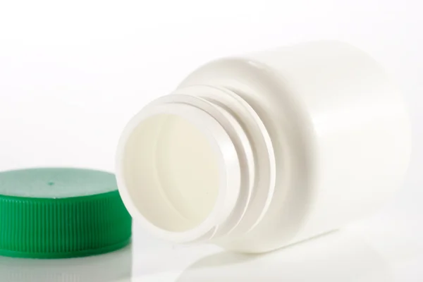 Bottiglia di medicinale vuota bianca sdraiata — Foto Stock