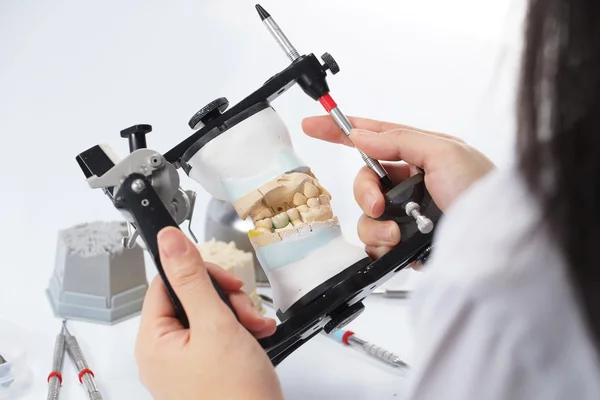 Dental technician working with articulator in dental laboratory — Stock Photo, Image