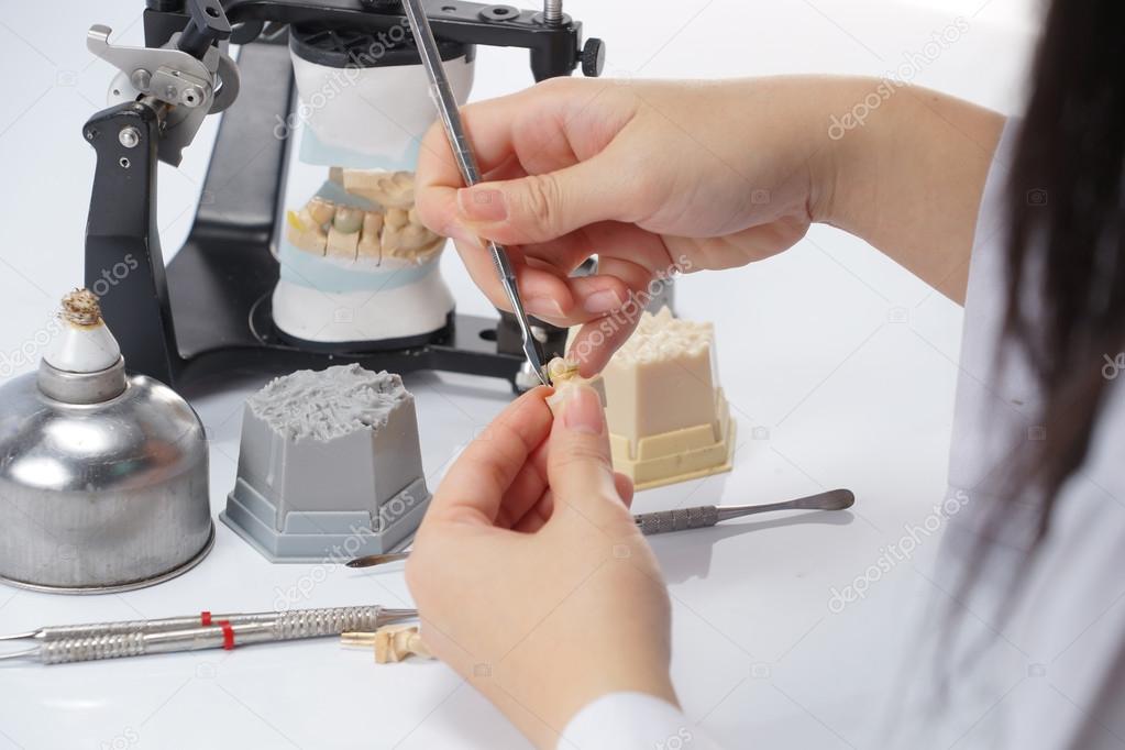 Dental technician working with articulator in dental laboratory — Stock