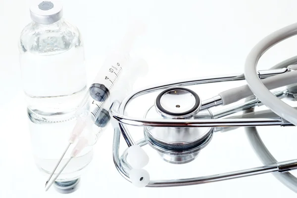Medical ampoules, syringe and stethoscope — Stock Photo, Image