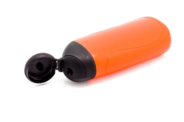 Оранжевые бутылки с черной крышкой — стоковое фото