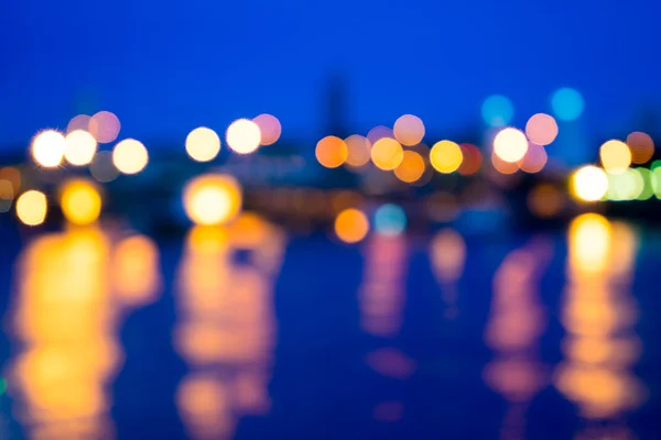 View of night light blur with reflection light in water — Stock Photo, Image