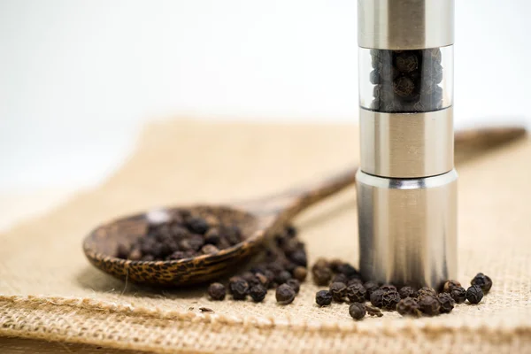 Pepper grinder and black peppercorn — Stock Photo, Image