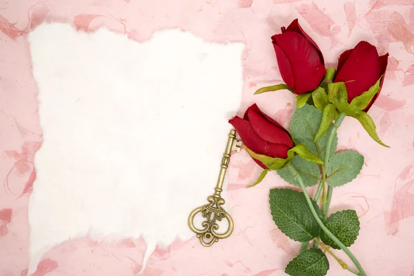 Papel em branco com rosa vermelha e chave velha — Fotografia de Stock