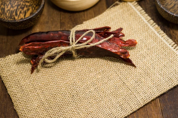 Dried chili on wooden table top — Stock Photo, Image