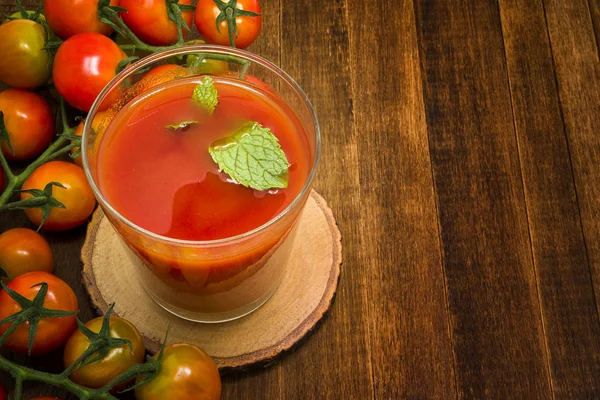 Glass of tomato juice on wooden table — Stock Photo, Image