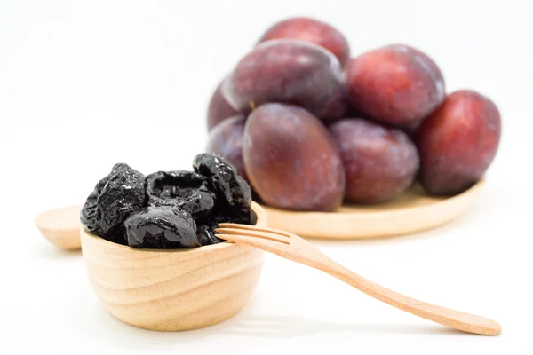 Delicious prunes in wooden bowl and fresh plums — Stock Photo, Image