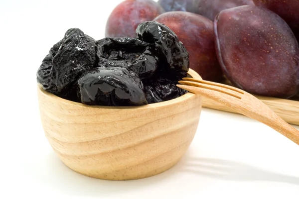 Delicious prunes in wooden bowl and fresh plums — Stock Photo, Image