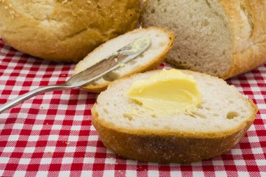 Tereyağı ile yuvarlak ekmek dilimlenmiş