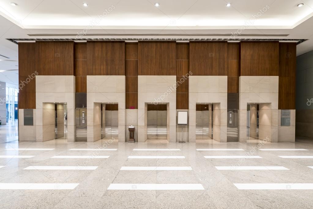 Five elevator doors in office building