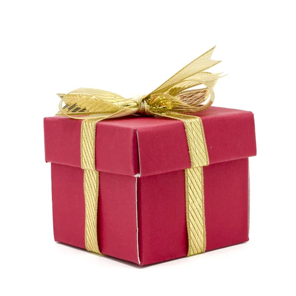 De doos van de gift van Kerstmis met een gouden lint boog — Stockfoto
