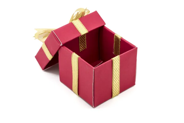 De doos van de gift van Kerstmis met een gouden lint boog — Stockfoto