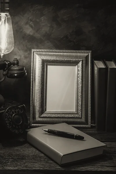 Still life of vintage telephone with picture frame and diary on — Stock Photo, Image