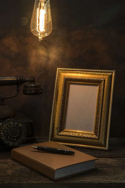 Still life of vintage telephone with picture frame and diary on — Stock Photo, Image
