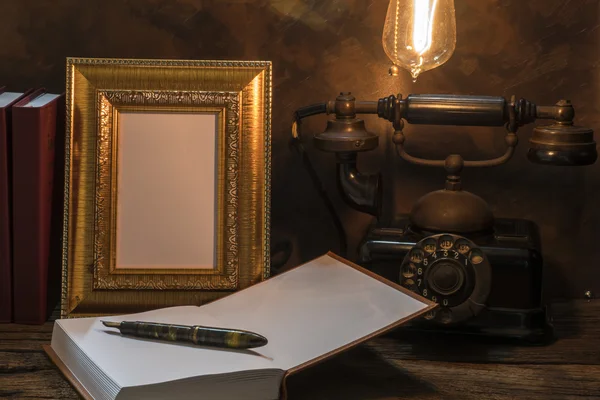 Still life of vintage telephone with picture frame and diary on — Stock Photo, Image