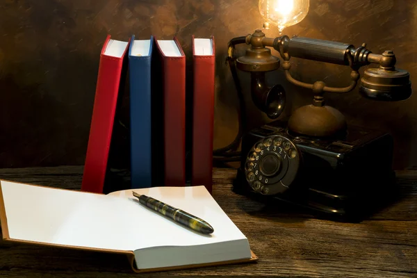 Still life of vintage telephone on table with diary book — Stock Photo, Image