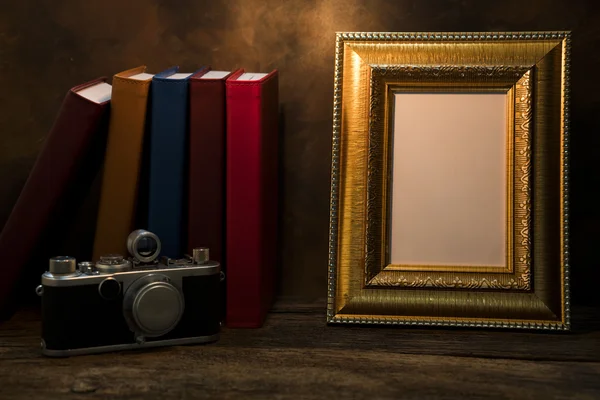 Picture frame on table with vintage camera and diary book — Stock Photo, Image