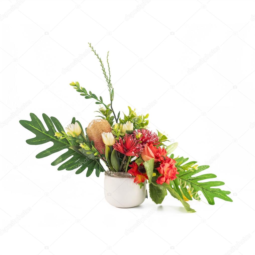 Artificial flowers in white vase on isolated  background