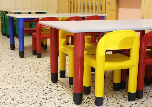 Sedie colorate nel refettorio della nursery con poltroncina — Foto Stock