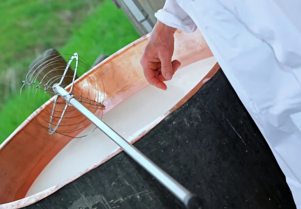 Cheesemaker vérifie à la main la température du lait à l'intérieur du c — Photo