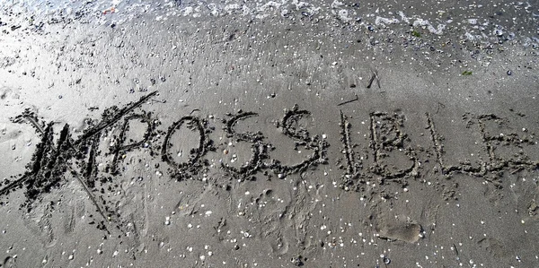 Onmogelijk geschreven op het zand — Stockfoto