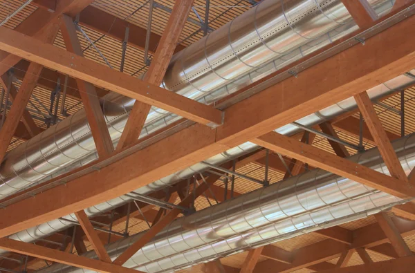 Tubes of an HVAC with roof with wooden beams in the new factory — Stock Photo, Image