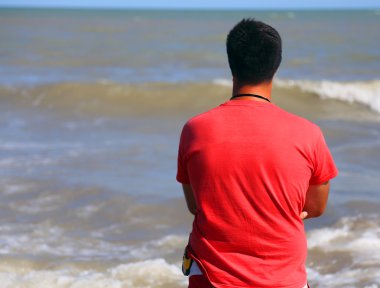 Lifeguard with red t-shirts when checking for swimmers in the se