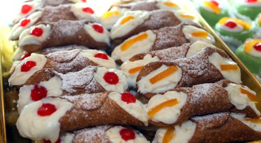 Sicilian cannoli with custard and cherries or candied fruit clipart