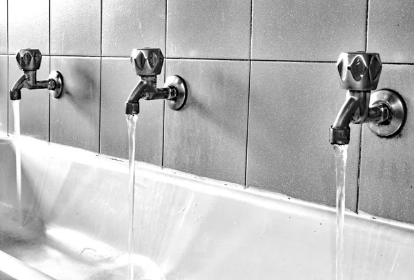 Many steel taps in the bathroom of kindergarten — Stock Photo, Image