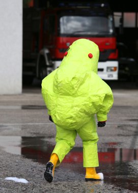 man with yellow protective suit against biological risk clipart