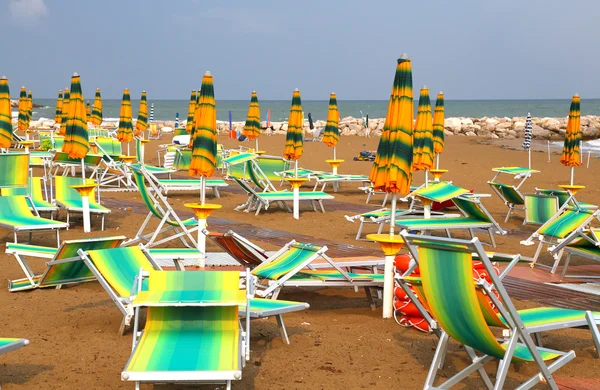 Sonnenschirme am Strand mit Liegestühlen und Liegestühlen — Stockfoto