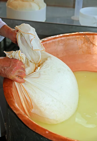 Cheesemaker の牧童が銅製の大釜 w からチーズを収集します。 — ストック写真