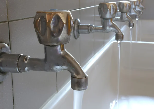 Steel taps in the bathroom of kindergarteners — Stock Photo, Image