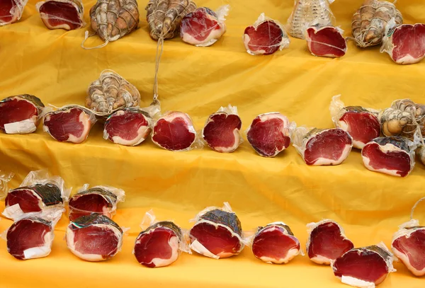 Ham and culatello vacuum packed for sale in Italian market — Stock Photo, Image